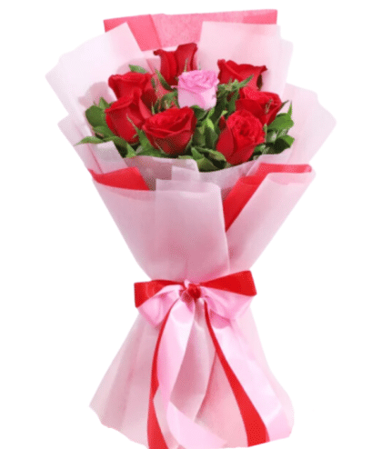 handbunch of red roses with single pink rose