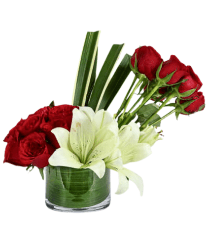 red roses and white lilies arrangement in glass vase