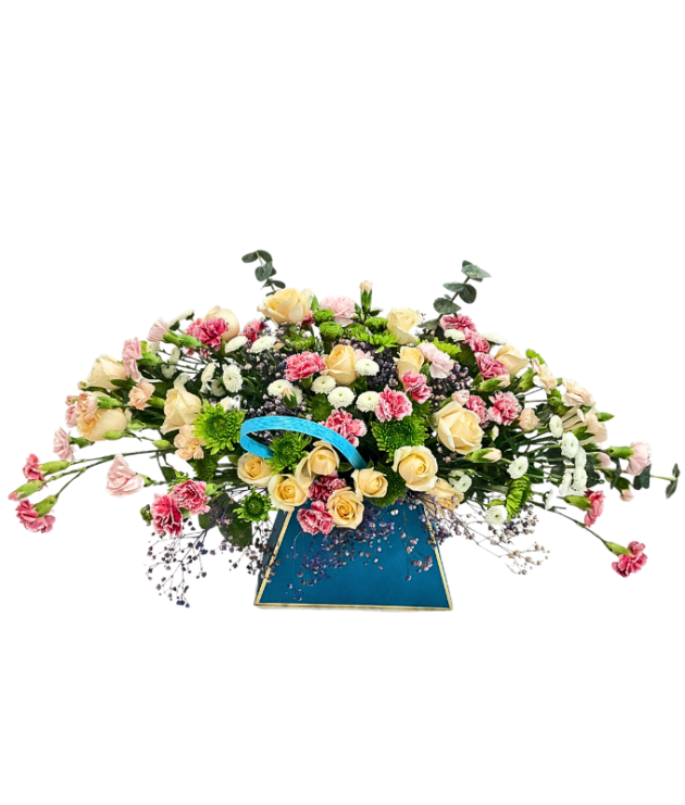 Peach roses , pink spray carnations,white button chrysanthemums,eucalyptus arrangement in blue bag