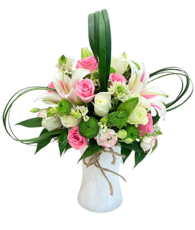 Baby pink roses,green button chrysanthemums,pink lilies white roses pastel look arrangment in white vase